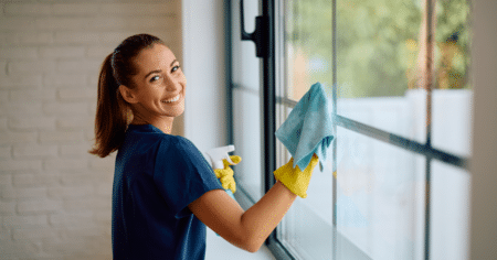 woman cleaning a window